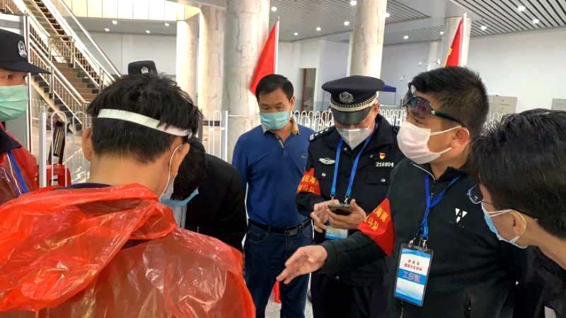 2陈国钏（右二）检查指导旅客和车辆交通行动轨迹填写.jpg